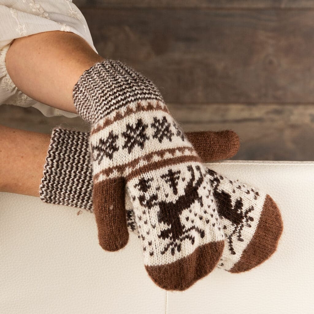 Warm wool mittens in dark brown and ecru, with cheerful deer motif.
