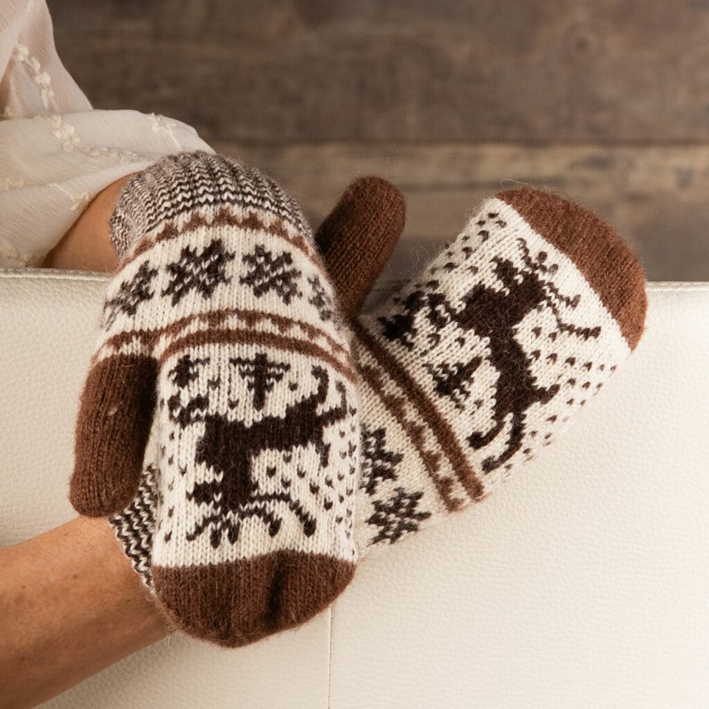 Warm wool mittens in dark brown and ecru, with cheerful deer motif.