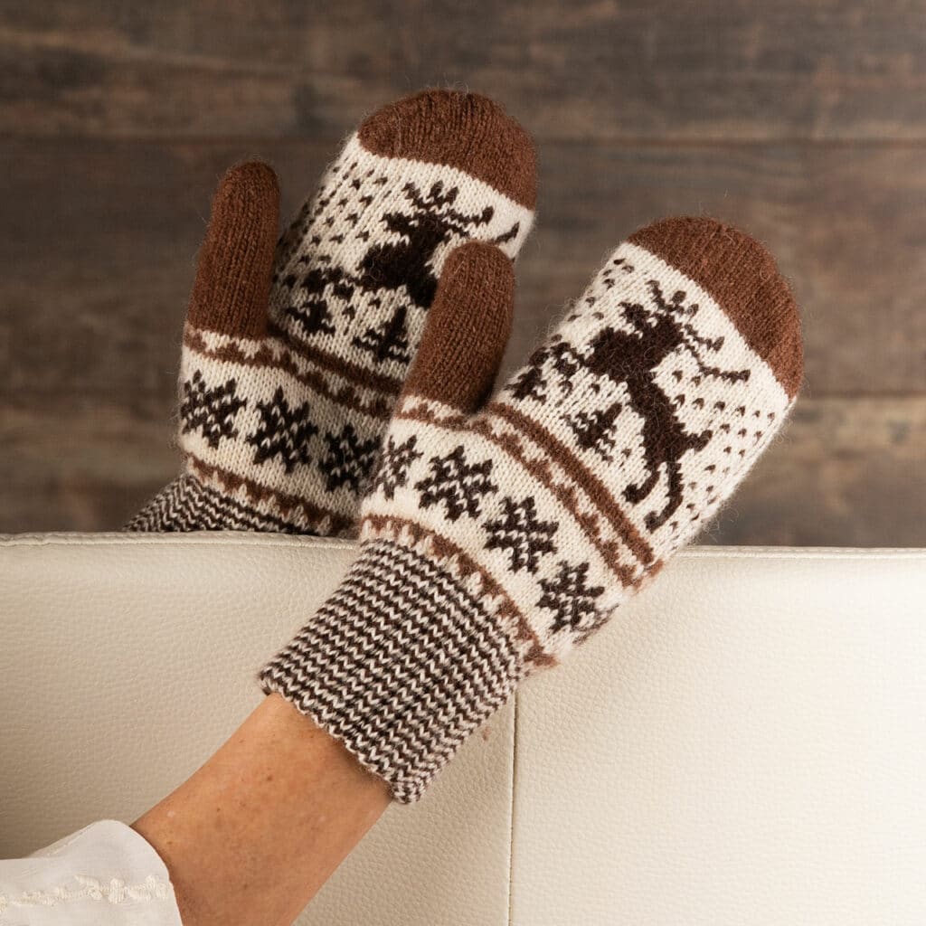 Warm wool mittens in dark brown and ecru, with cheerful deer motif.